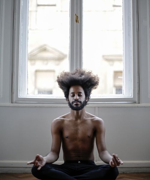 Person practicing gentle stability yoga poses indoors
